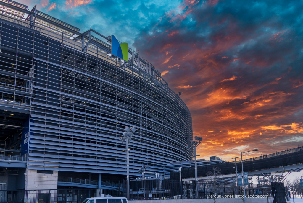 Exterior view of MetLife Stadium in East Rutherford, New Jersey, photographed against a sunset sky.